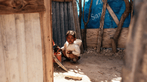 Small child inside of a home in a poor area